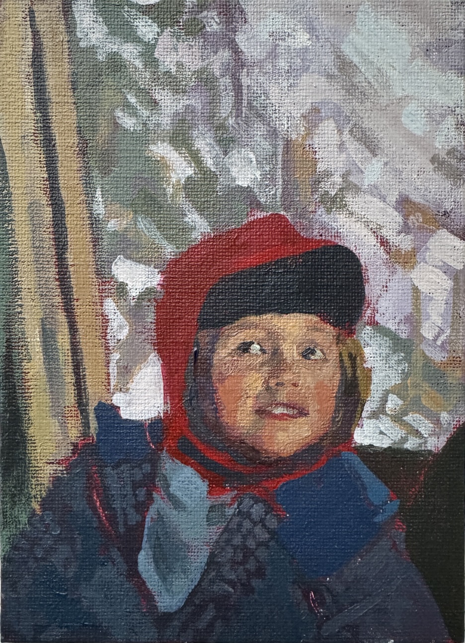 A young girl in a red hat sits in a gondola.
